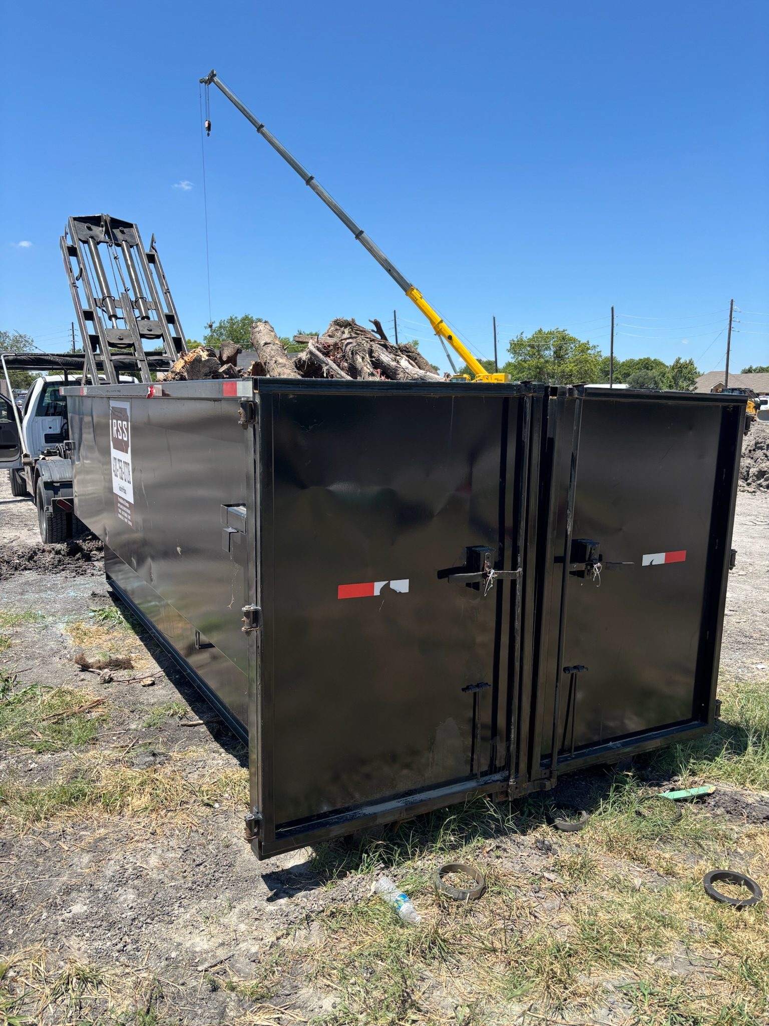 RSS dumpster being loaded on a job site